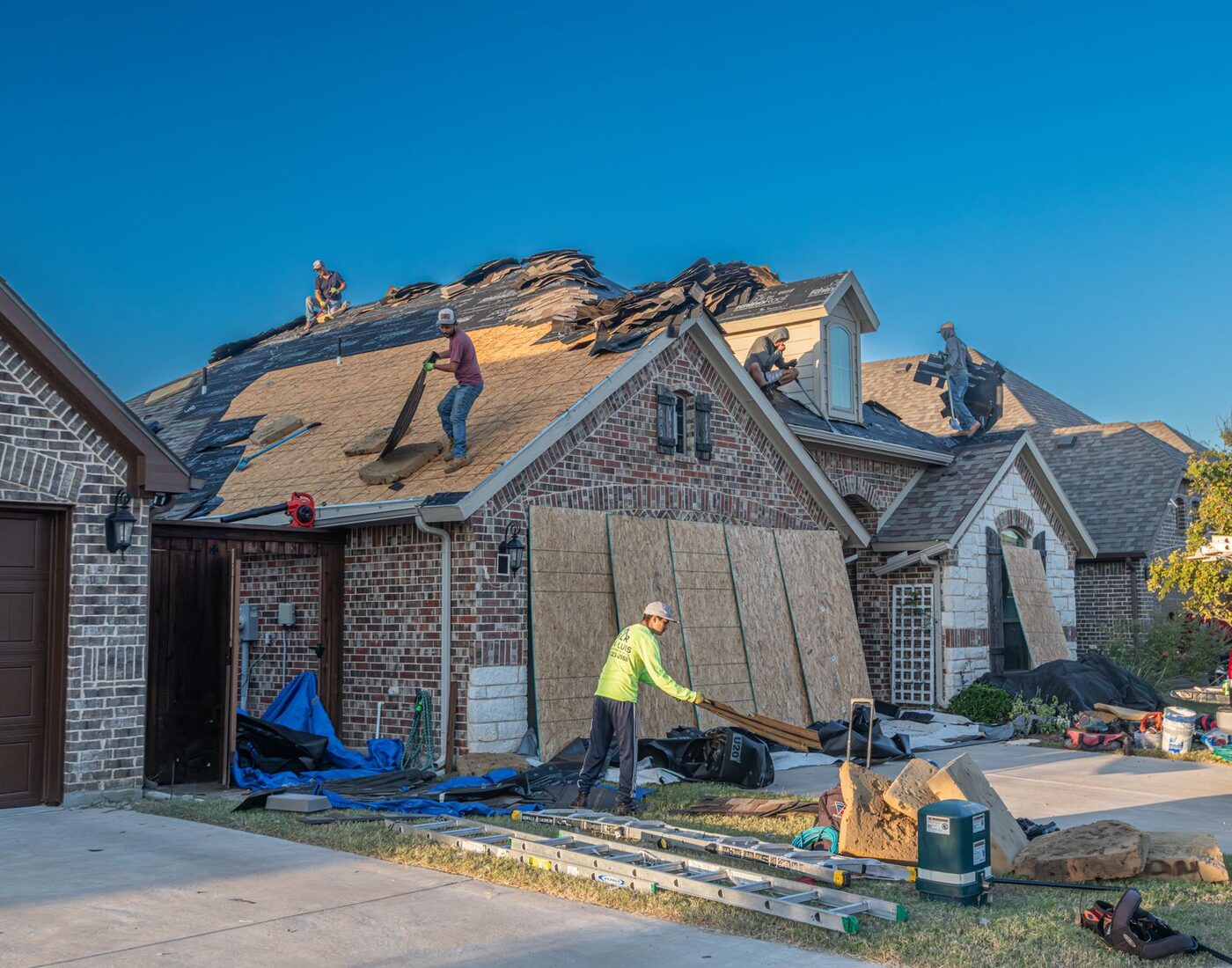 Roofing crew replacing the roof on a suburban home